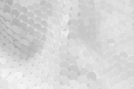 Background sequin. Holiday abstract glitter background with blinking lights. Fabric sequins in white color. Fashion fabric glitter.の写真素材