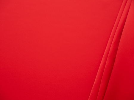 Beautiful smooth elegant wavy hot red satin silk luxury cloth fabric texture, abstract background design. Wallpaper, banner or card with copy space.の写真素材