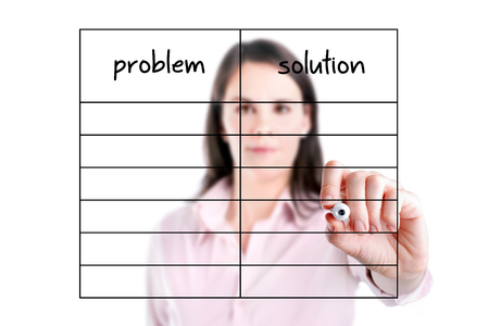 Young business woman writing problem and solution in blank list.の写真素材