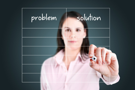 Young business woman writing problem and solution in blank list.の写真素材