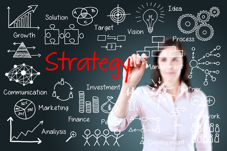 Young business woman writing business strategy conceptの写真素材