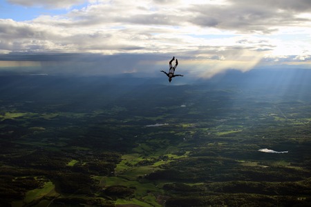 Skydiving over beautiful Norway. Clouds, sun and skyの写真素材