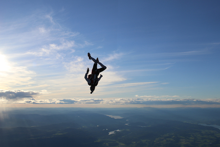 Skydiving over beautiful Norway. Clouds, sun and skyの写真素材