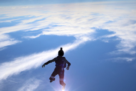 Skydiving over beautiful Norway. Clouds, sun and sky