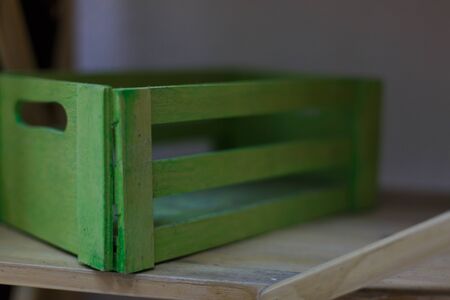 An open ended small wooden crate isolated on white. The construction of this container shows gaps between the planks or slats and is typically used to display or store items.の写真素材