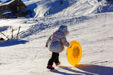Five-year girl standing with hands ledyankah about icy hillの写真素材