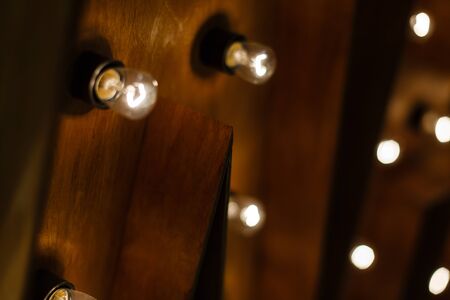 Vintage message board with light box and light bulb on wooden wall wooden box and light bulbsの写真素材