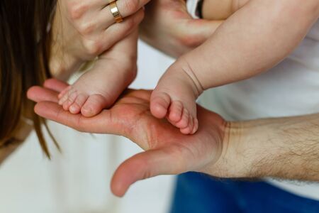 newborn feet in handsの写真素材