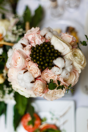 Beautiful winter wedding bouquet with cones, cotton and spruce branches Bruno. Bride holding a bridal bouquet.の写真素材