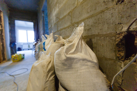 Repairs to a new apartment. Bags of cement and the underlay for laminateの写真素材