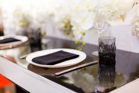 Wedding. Banquet. Mr. Mrs. signs on wooden board decorated by flowers and greenery and lounge zone including chairs and tables.の写真素材