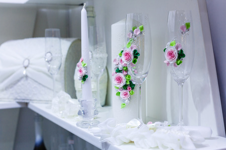 Wedding decorations for the ceremony in white flowers on green background, candles, tablewareの写真素材