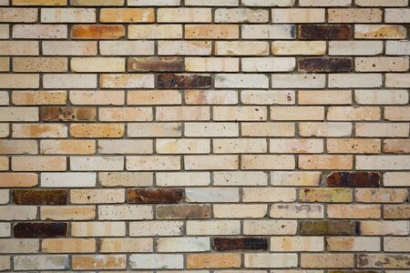 Background on an old yellow brick wallの写真素材