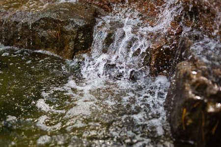 Close up of water splashing on rocks from a waterfall Water on decorative stonesの写真素材