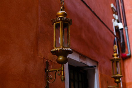 Street lamp on a red wall background. Wall with street lamp.の写真素材