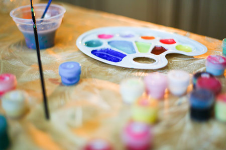 Hand painting eggs on wooden table. It is colorful.