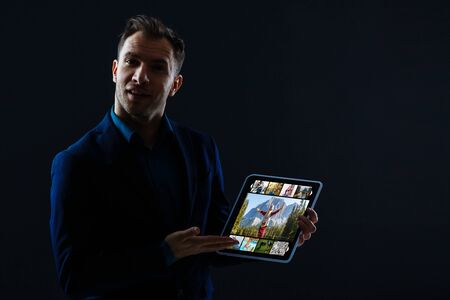 Close-up Of Young Man Playing Video Game On Tablet Pcの写真素材