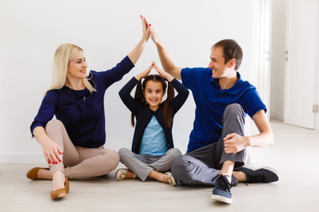 playful family sitting and smiling indoors