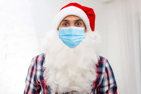 Illness and colds. santa claus in medical mask. background.の写真素材