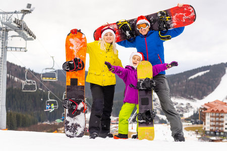 Winter time and skiing - family with ski and snowboard on ski haの写真素材
