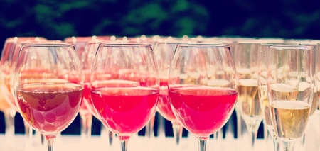 glasses with white and red wine close-up before party in cafeの写真素材