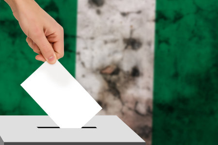 hand drops the ballot election against the background of the flag, concept of state elections, referendumの写真素材