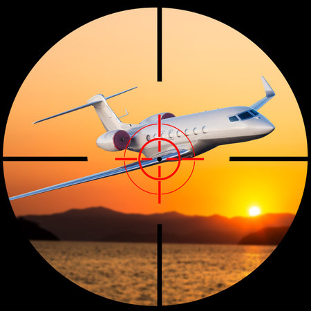 Airplane in the sight of anti-aircraft weapons. Missile defense system aimed at passenger plane in the sky. The unidentified plane flies over the war zone with danger crash. Attack to civil jet aimの写真素材