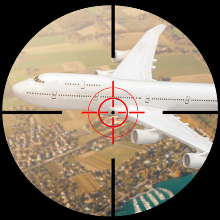 Airplane in the sight of anti-aircraft weapons. Missile defense system aimed at passenger plane in the sky. The unidentified plane flies over the war zone with danger crash. Attack to civil jet aimの写真素材