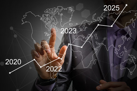 Mans hand pointing graph of success in 2023 year. Growing business concept