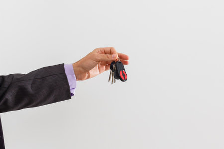 businessman holding a car keyの写真素材