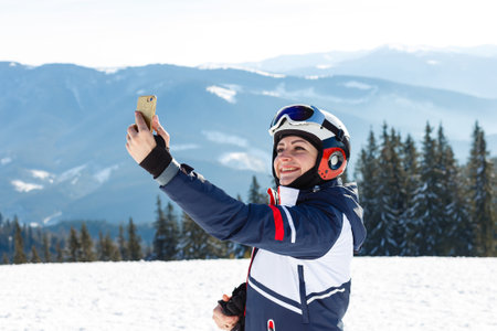 Woman skier enjoy in winter sunny day, holidayの写真素材
