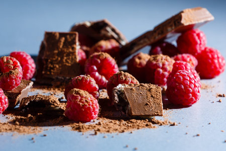 raspberries with chocolate on gray background chocolate