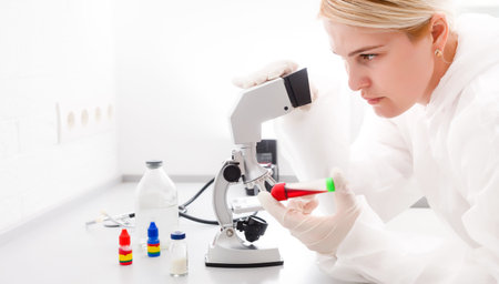 Woman working with a microscope in lab