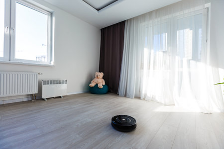 Robotic vacuum cleaner on parquet - technology houseworkの写真素材