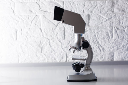 microscope stands on a table on a white backgroundの写真素材