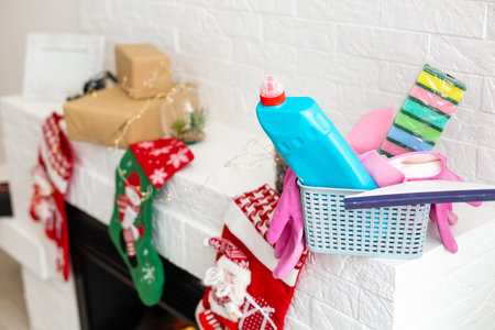 Different tools for cleaning in kitchen over christmas backgroundの写真素材