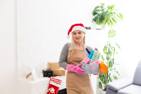 Woman wearing festive decorations ready for cleaning after Christmasの写真素材