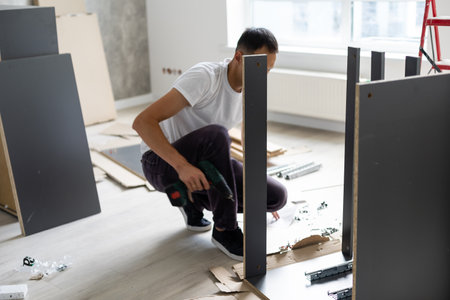 furniture, home and moving concept, installation and assembly of furniture in a new apartmentの写真素材