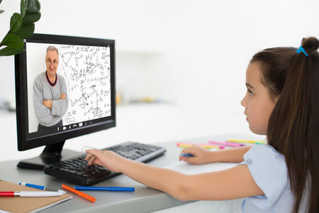 Pretty stylish schoolgirl studying homework math during her online lesson at home, social distance during quarantine, self-isolation, online education concept, home schoolerの写真素材