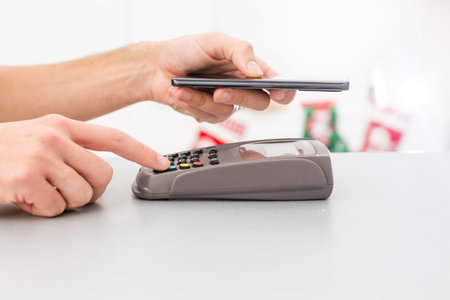 Contactless mobile payment. Payment terminal and smartphone in hands
