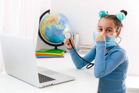 Learning about all sorts of stuff on the web. Little girl uses the mask as a pandemic protection....