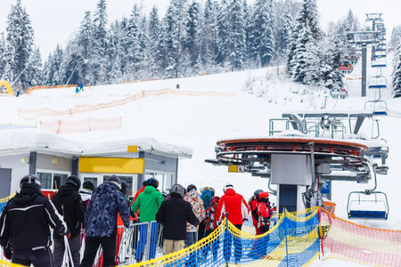 Skiers queuing for a chair-liftの写真素材