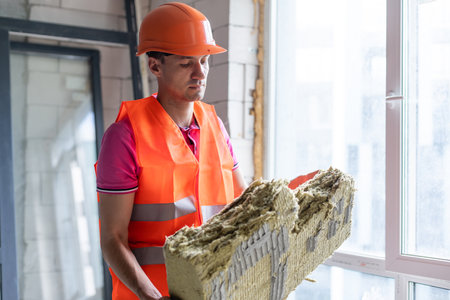 Young worker makes repair in a new apartmentの写真素材
