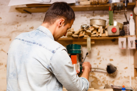 Carpenter works in a workshop for the production of vintage furnitureの写真素材