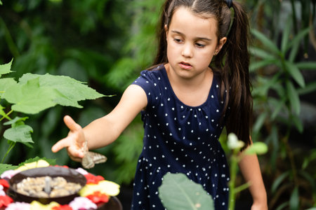 Little girl holding butterfly in her hand.の写真素材