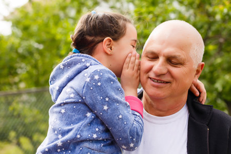 Little girl spending time with grandfather in the park.の写真素材