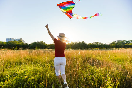 woman with a kite in the fieldの写真素材