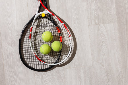 Tennis iquipment against a wooden backgroundの写真素材