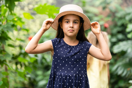 two little girls with butterflies in a greenhouseの写真素材
