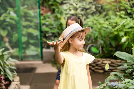 Little girl holding butterfly in her hand.の写真素材
